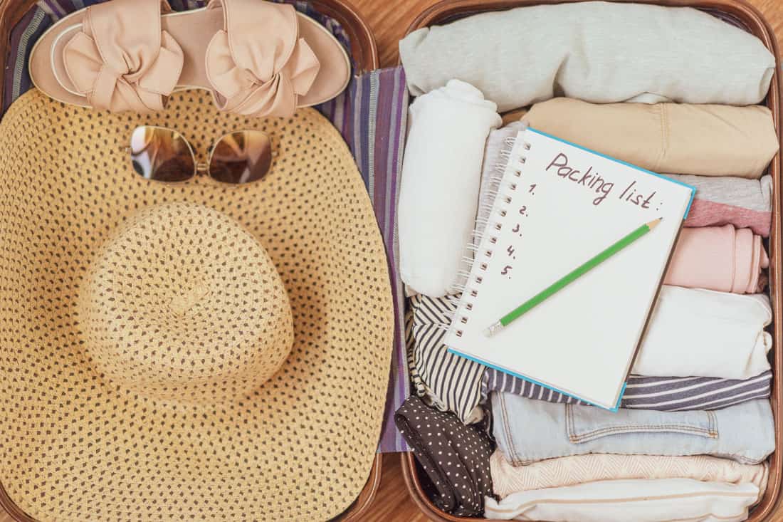 a packed suitcase and packing list for senior living