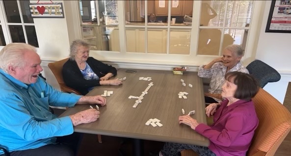 Senior residents play a game of dominos.