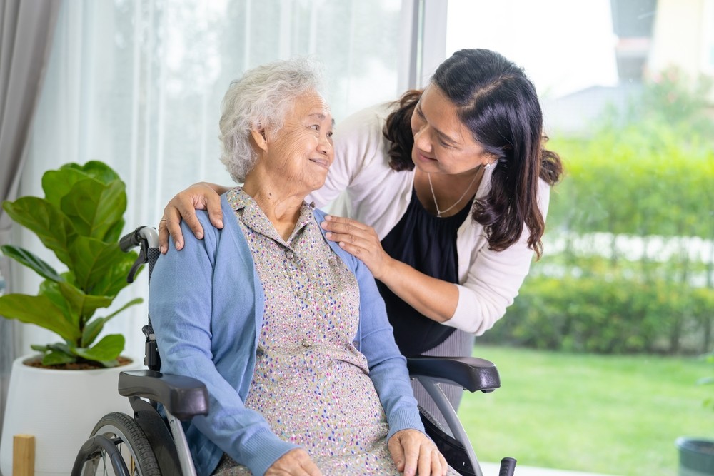 Senior woman smiling with caregiver