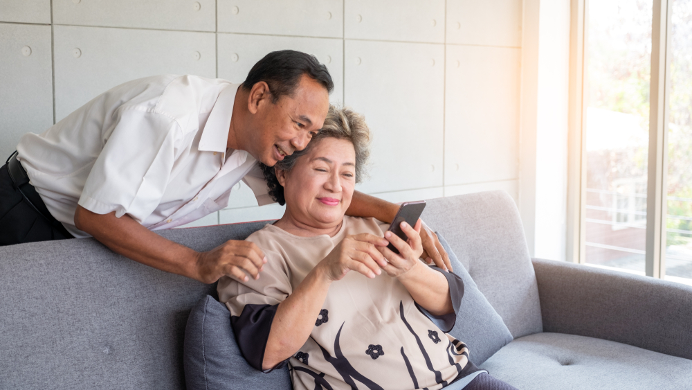 a senior couple looks on their phone at skilled nursing options