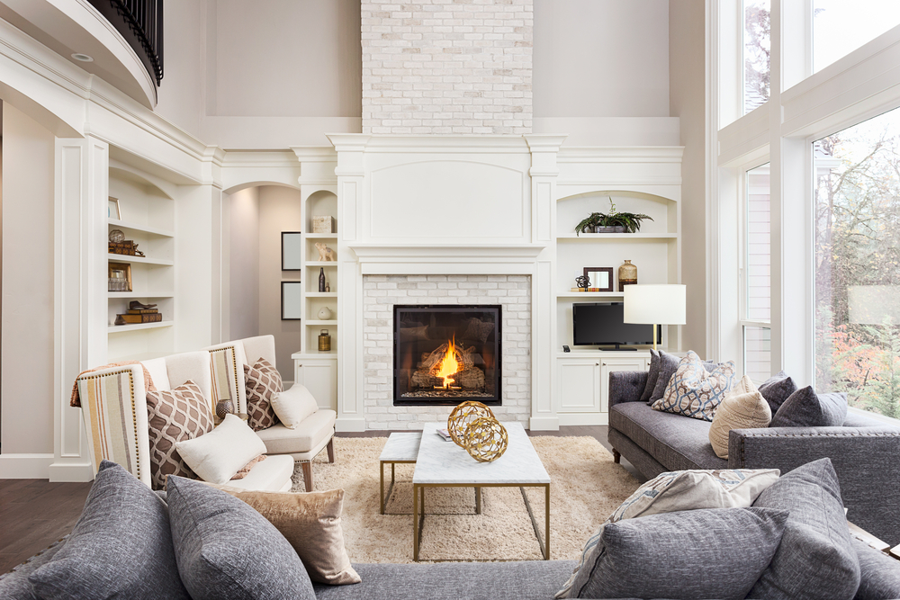 A modern home with a white fireplace and blue couch